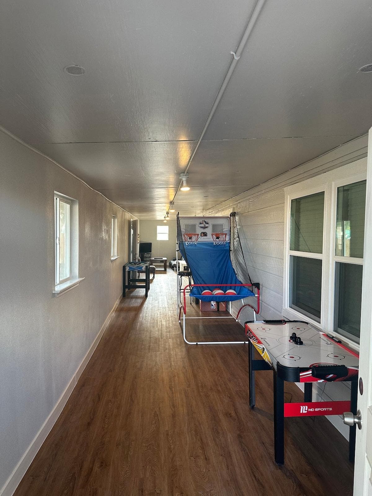 The indoor Gameroom features various games. Including a Ice hockey table and basketball hoop.