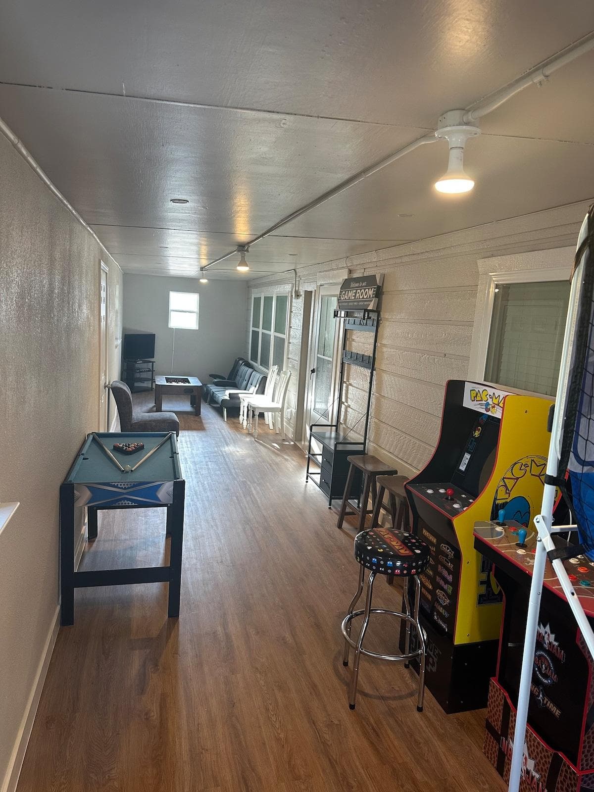On the other end of the Gameroom you will find a couple arcades, pool table, and a sitting lounge to connect your gaming system. 